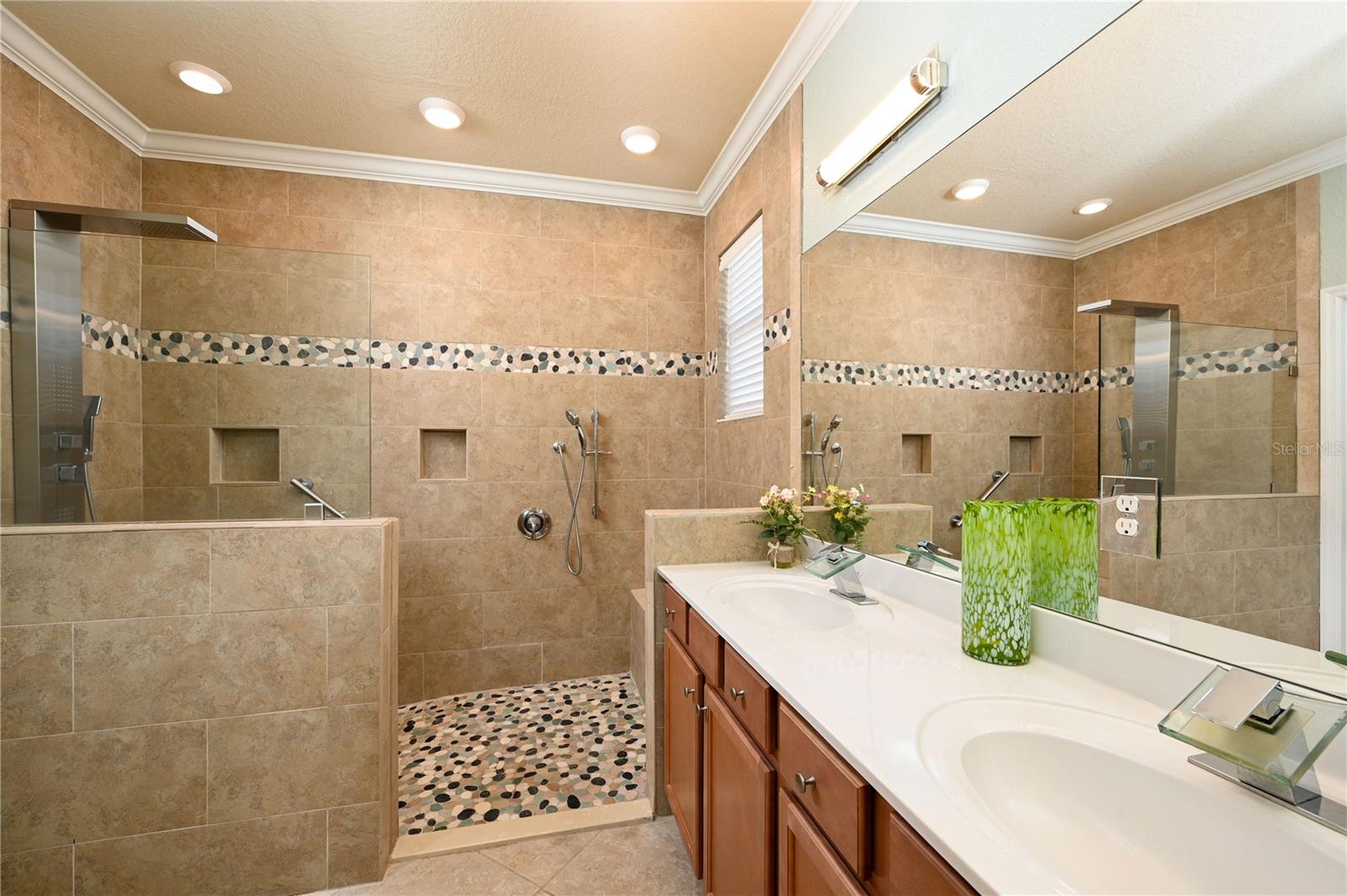 Primary ensuite bath with shower tower and seated bathing