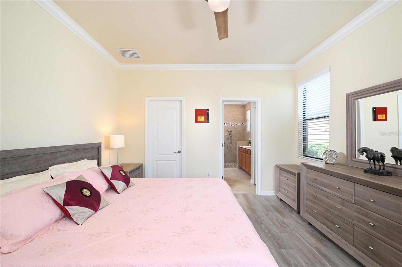 Primary bedroom facing bath and walk in closet