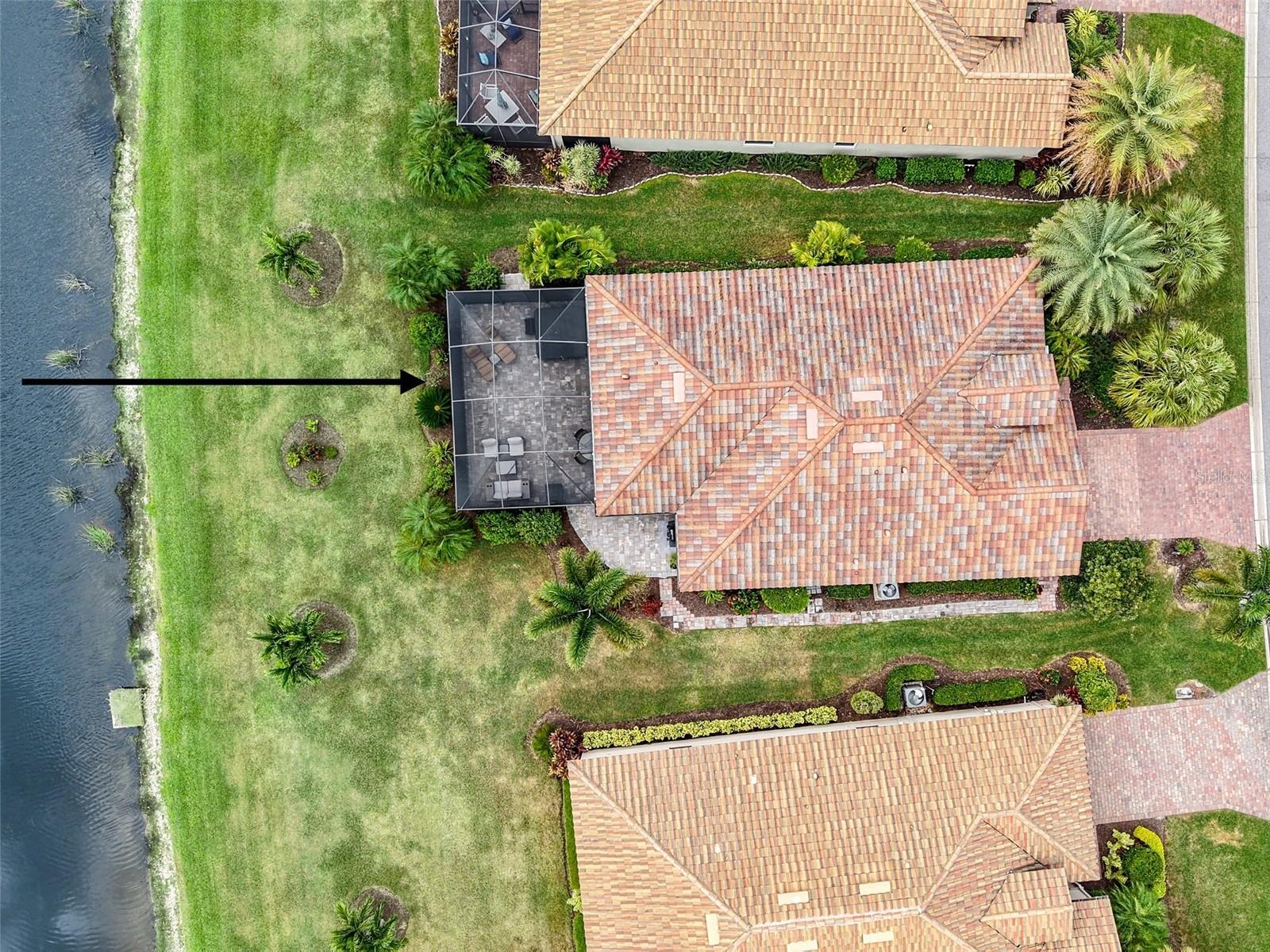 Aerial view of house facing west, pond on left