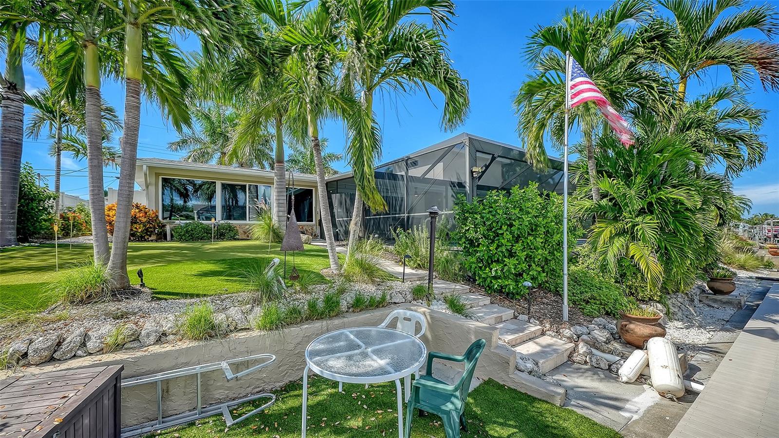 Enjoy a relaxed waterside seat beneath the palms.
