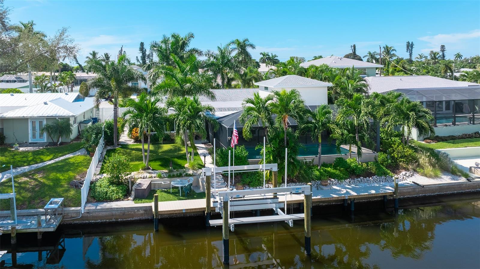 Your saltwater waterfront retreat, with a pool, dock, golf and tropical landscaping.