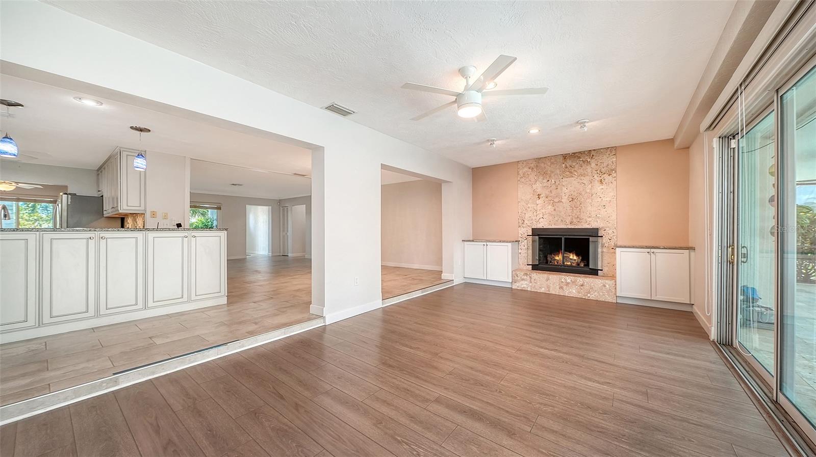 A fireplace adds warmth to the connected living space.