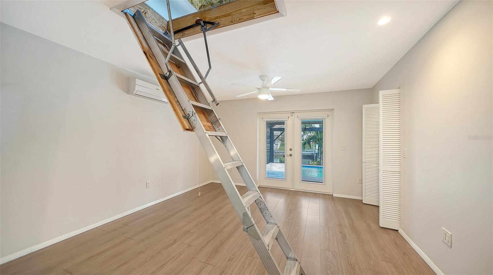 Pull-down stairs provide access to the overhead storage area.