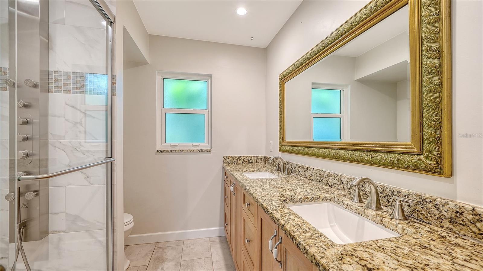 A spacious vanity and glass shower for daily comfort.