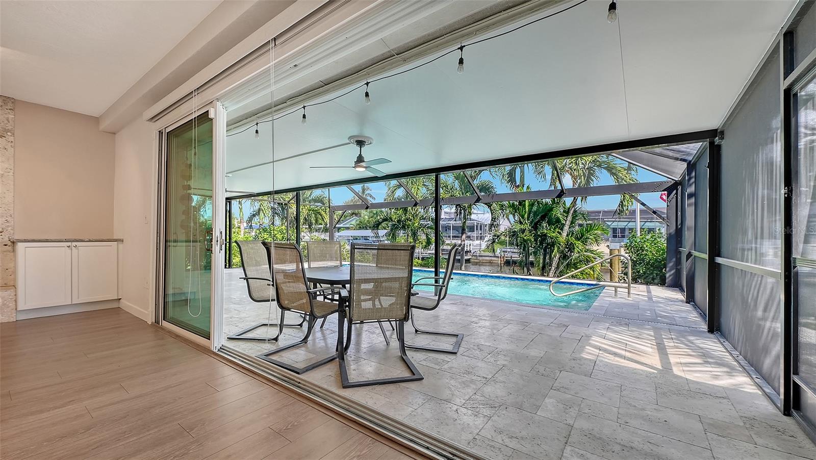 Retractable sliding doors connect indoor comfort and outdoor relaxation.