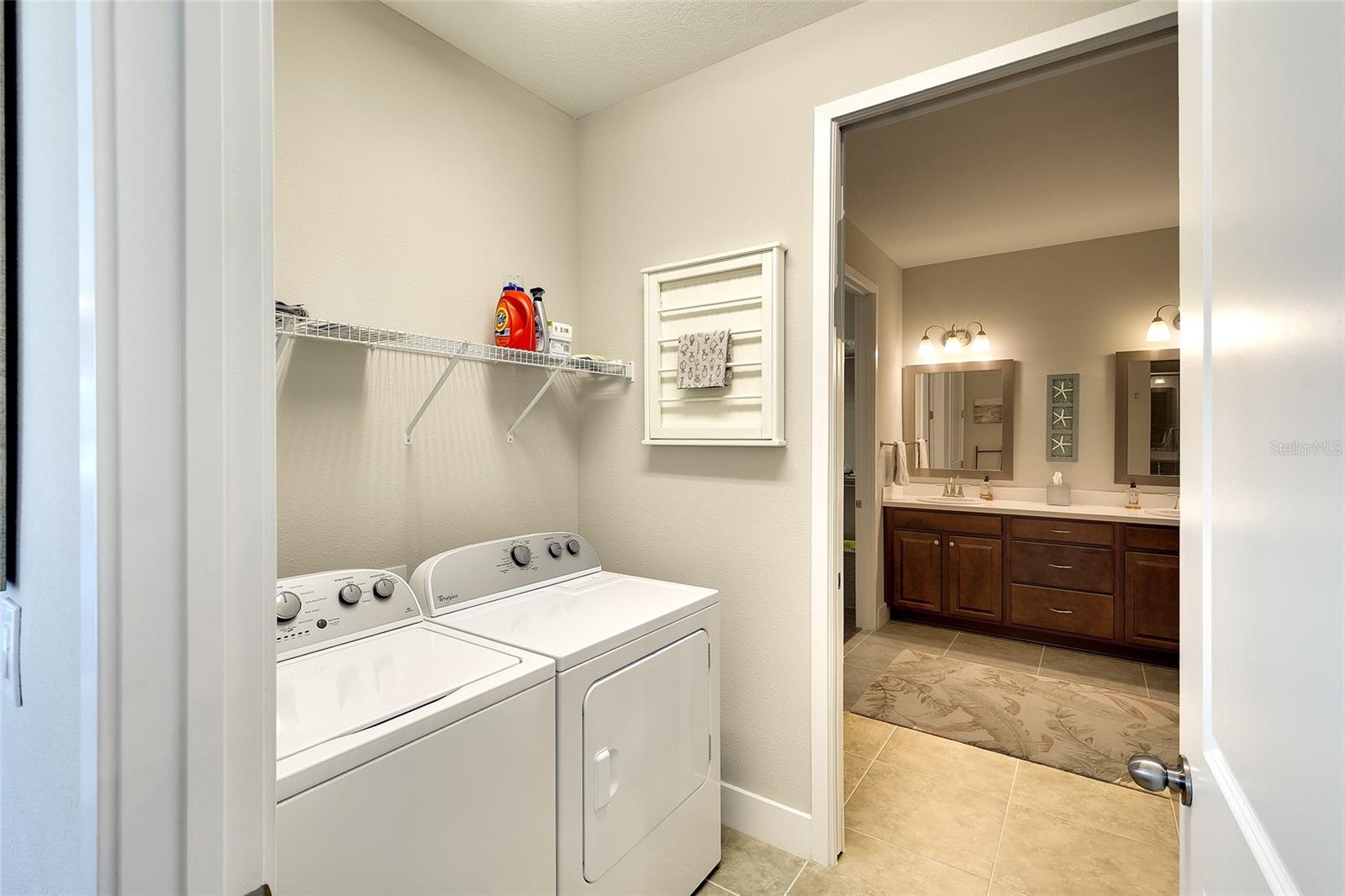 Pass through laundry room, conveniently located to kitchen and owner's bath