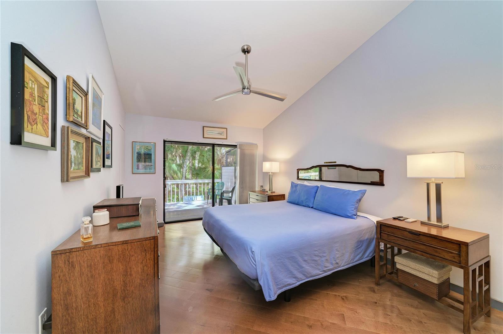 Primary bedroom with sliders out to the open back deck