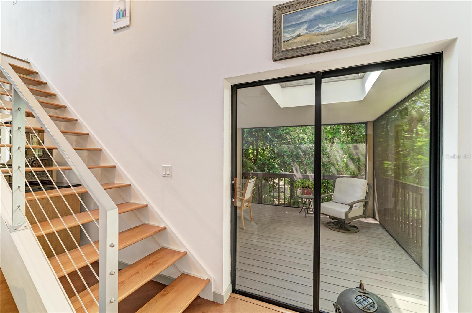 Sliders out to the lanai and stairs to the loft