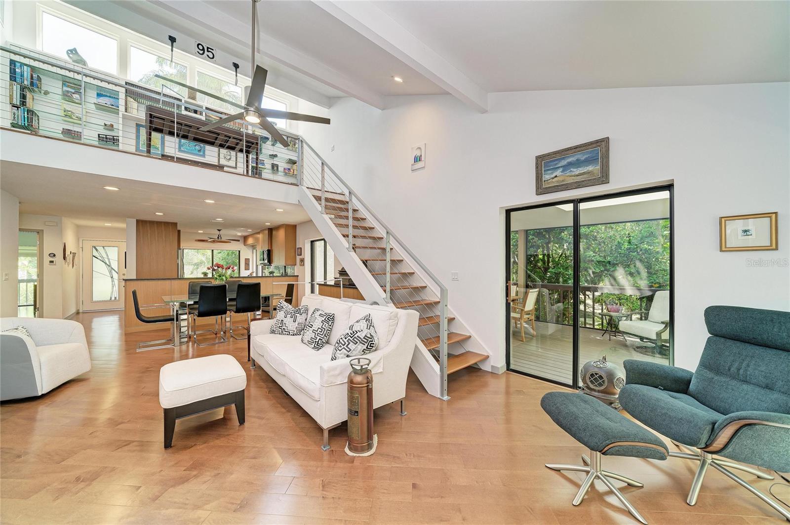 Open floor plan with living/dining, stairs to the loft and kitchen under the loft.