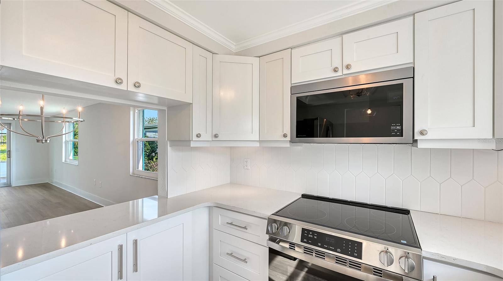 New Kitchen with stone countertops and stainless steel appliances. Pass through to Dining Room.