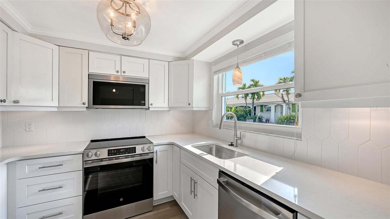 New Kitchen with stone countertops and stainless steel appliances.