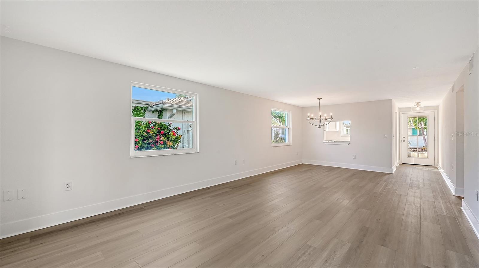 The entry door, Kitchen on the left, Dining Room/ Living Room combination.