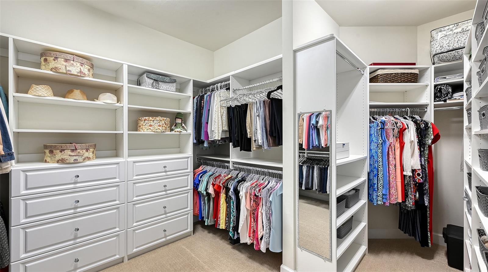 Primary closet with custom built-ins with an abundant amount of space for true luxury living.