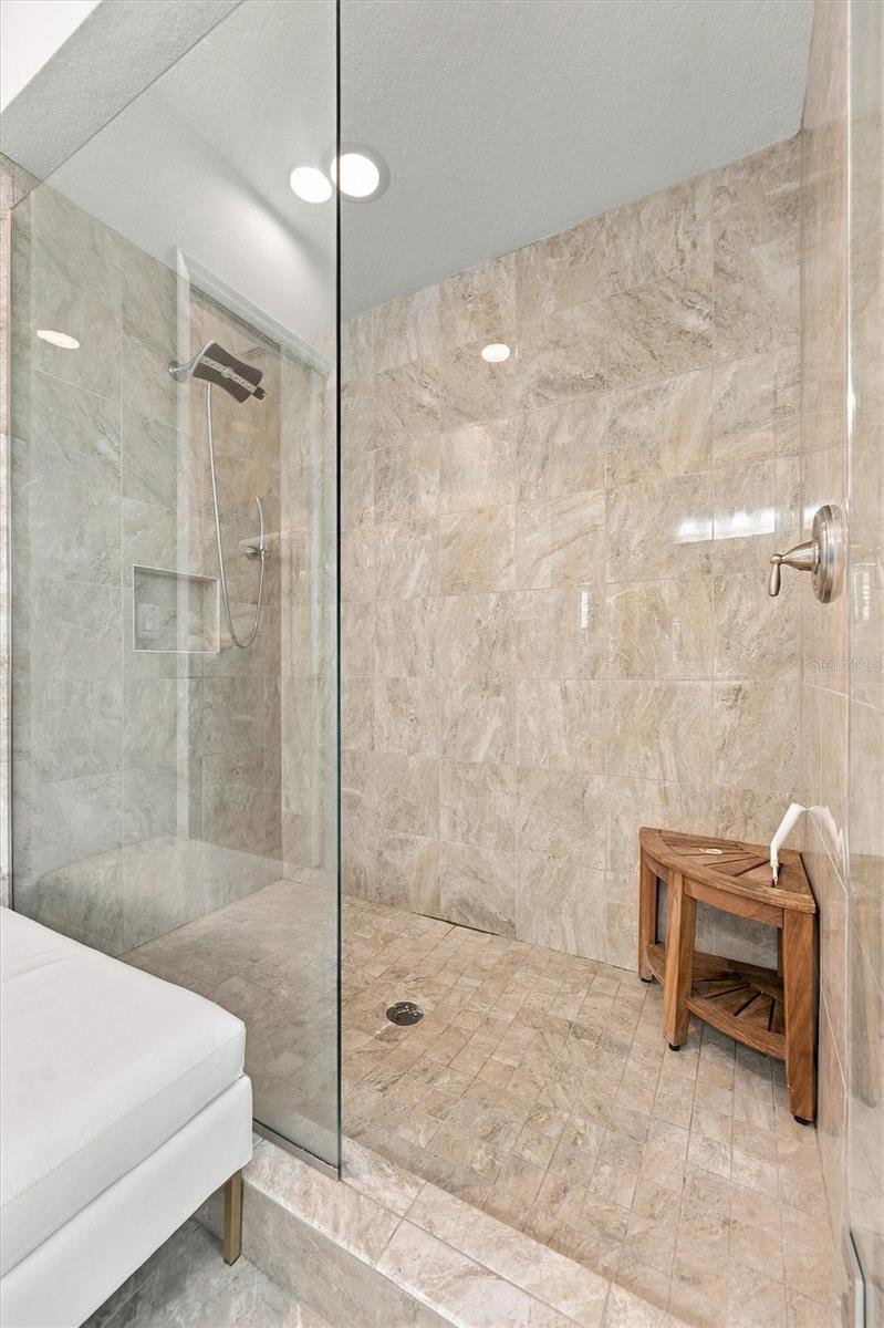The spacious primary ensuite features dual vanities, a large walk-in shower, a private water closet, and convenient access to one of the suites two walk-in closets.