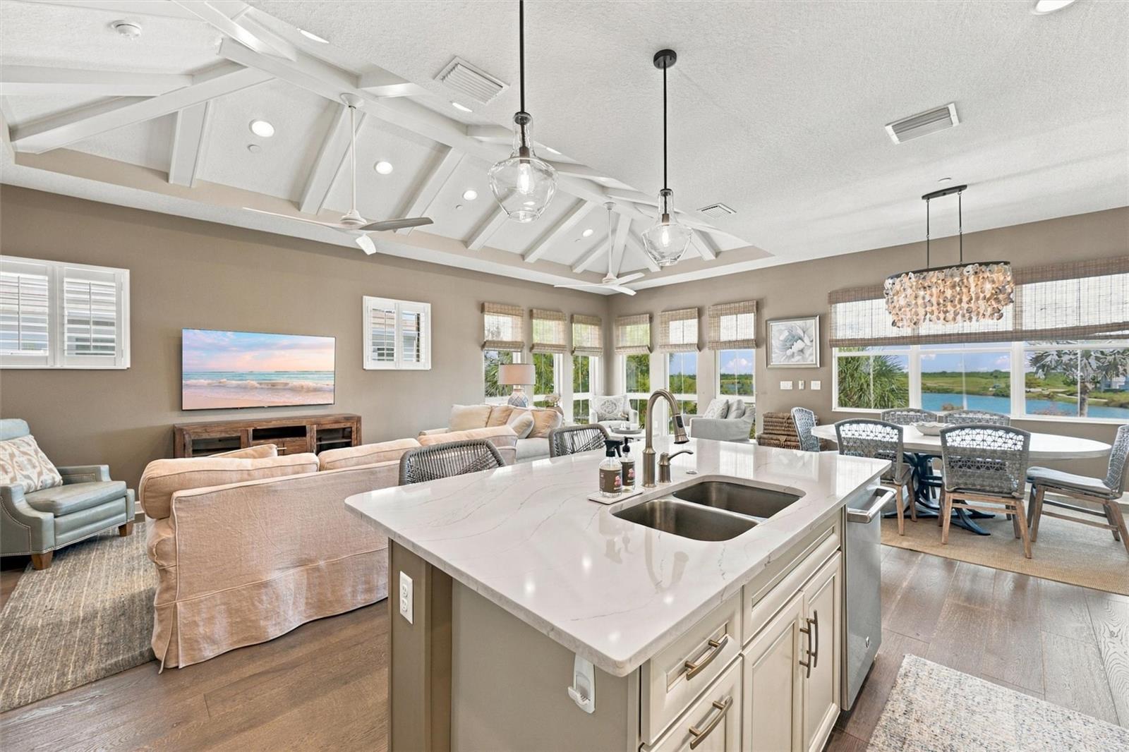 Enjoy peaceful Sapphire Lake views from this beautifully appointed home, featuring an open-concept floor plan, soaring vaulted ceilings, and Mohawk engineered hardwood flooring.