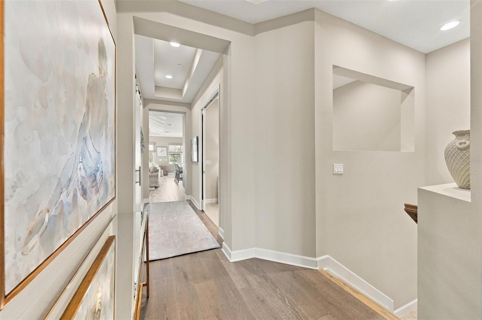 Hallway up the stairs that lead to the Bonus Room, Kitchen and Living Room area.