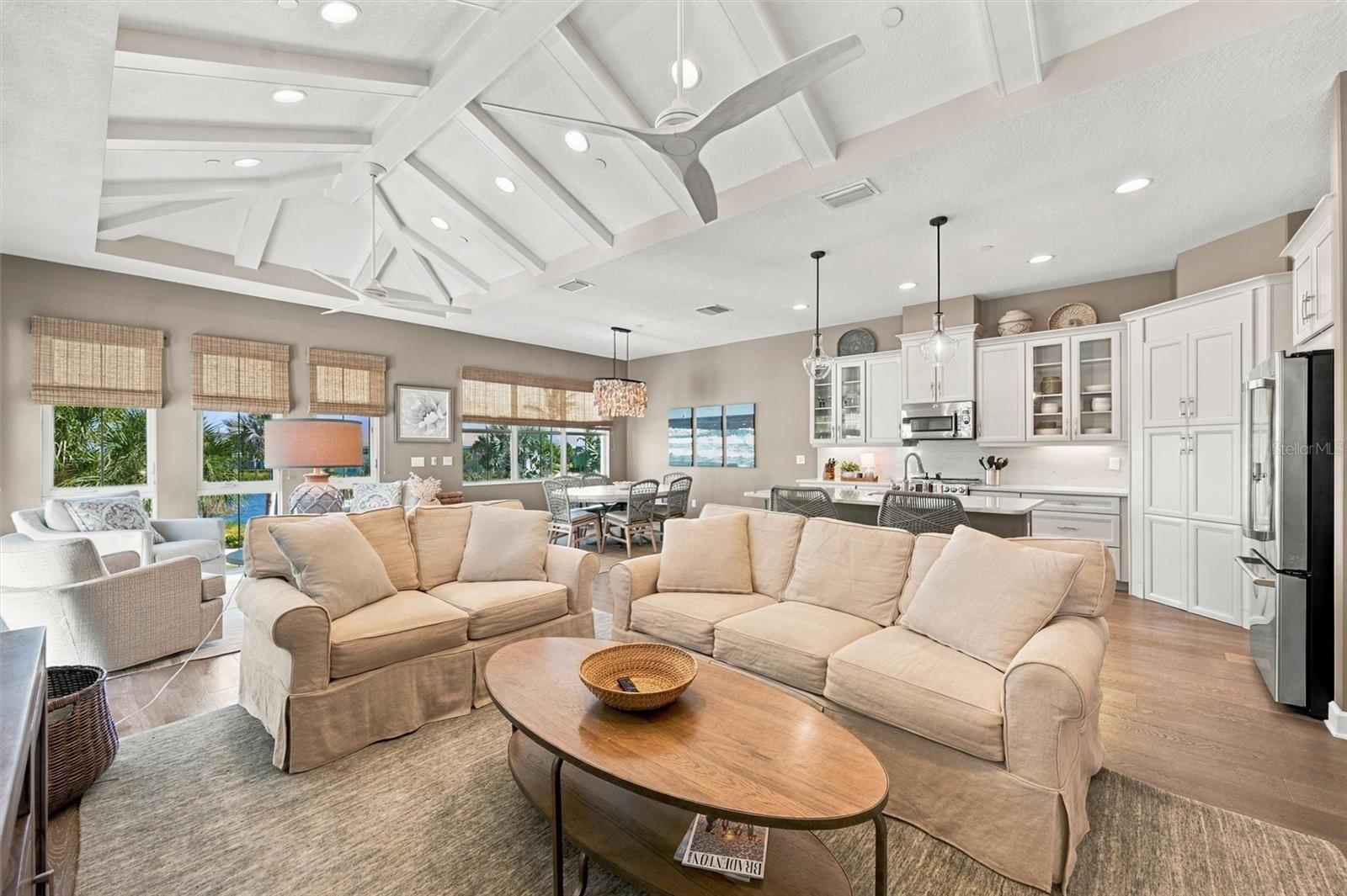 Enjoy peaceful Sapphire Lake views from this beautifully appointed home, featuring an open-concept floor plan, soaring vaulted ceilings, and Mohawk engineered hardwood flooring.