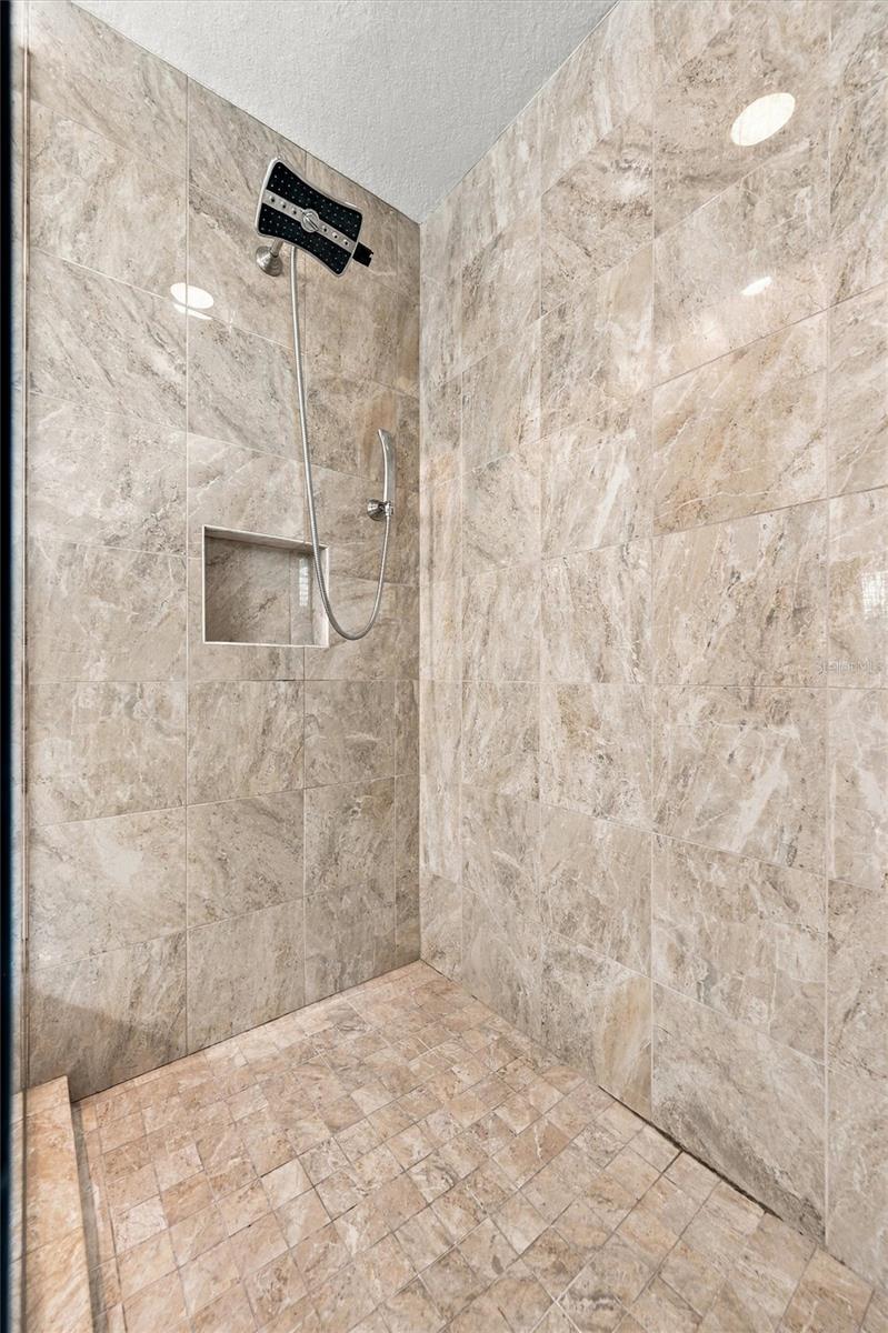 The spacious primary ensuite features dual vanities, a large walk-in shower, a private water closet, and convenient access to one of the suites two walk-in closets.