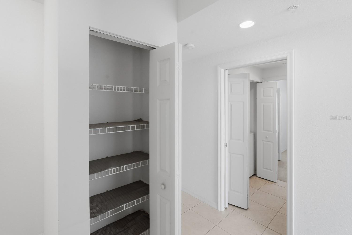 Kitchen Pantry across the hall from Guest Bedroom and Laundry Closet.