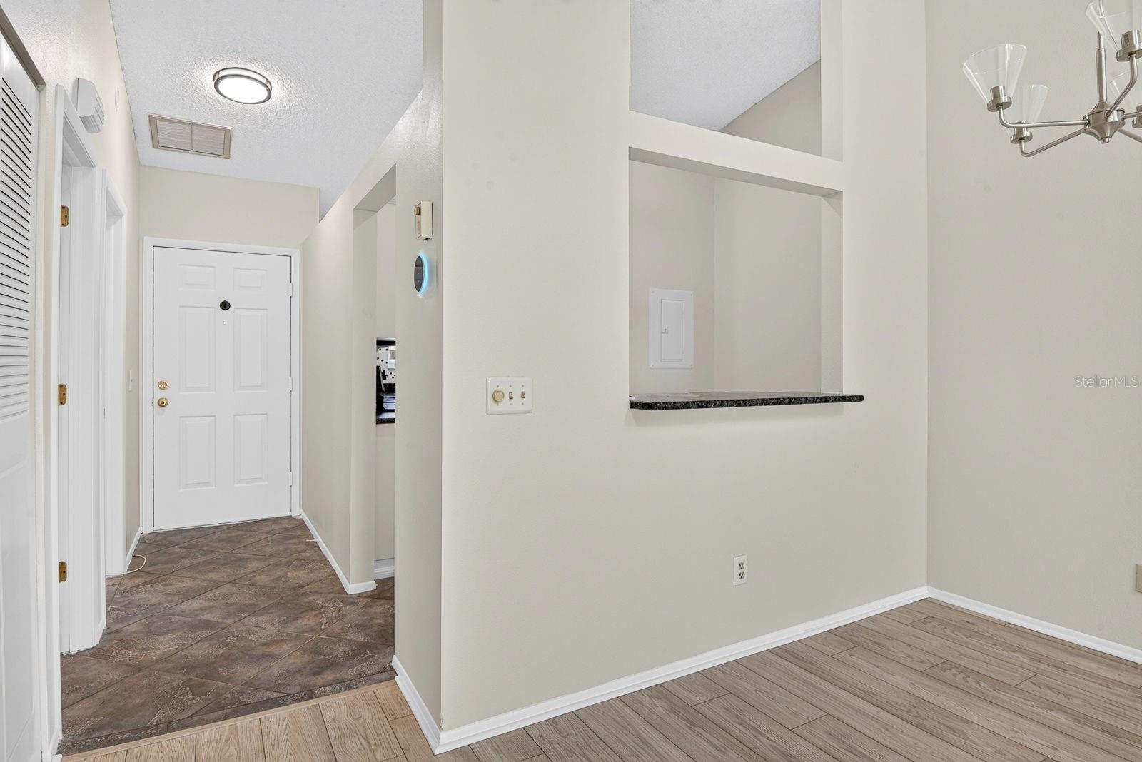 Dining area with Kitchen behind and entryway