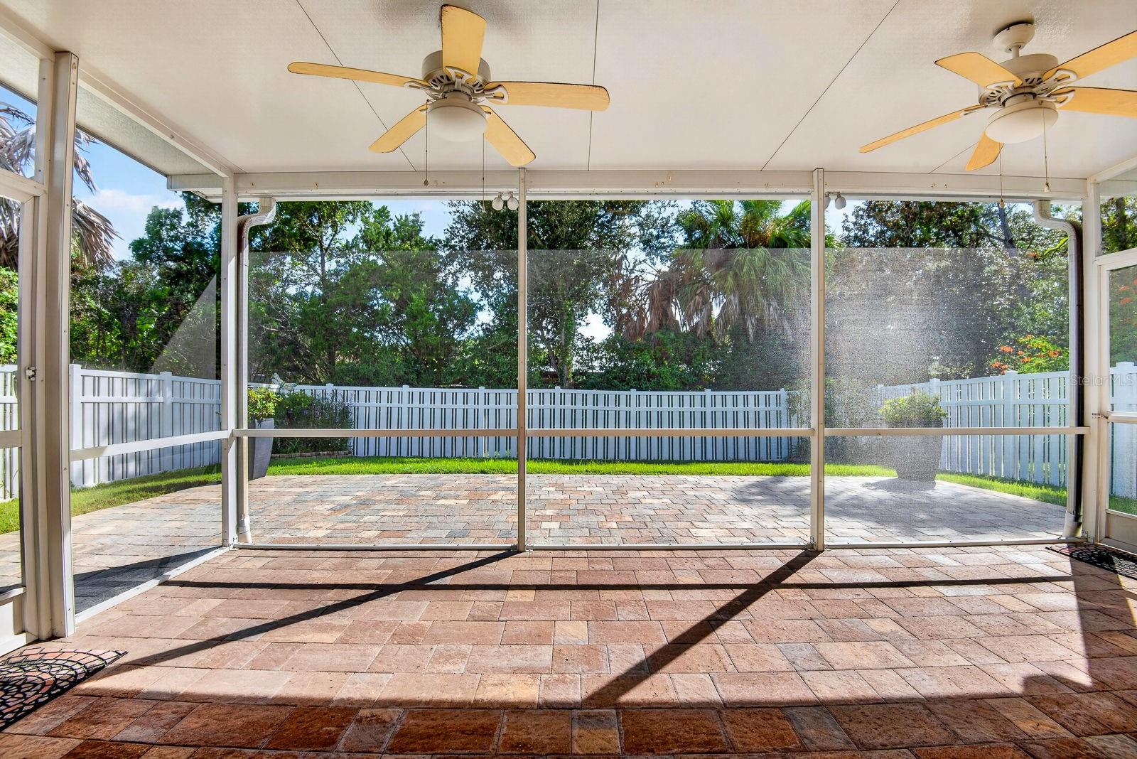 Large screened in Lanai facing out with extended pavers outside