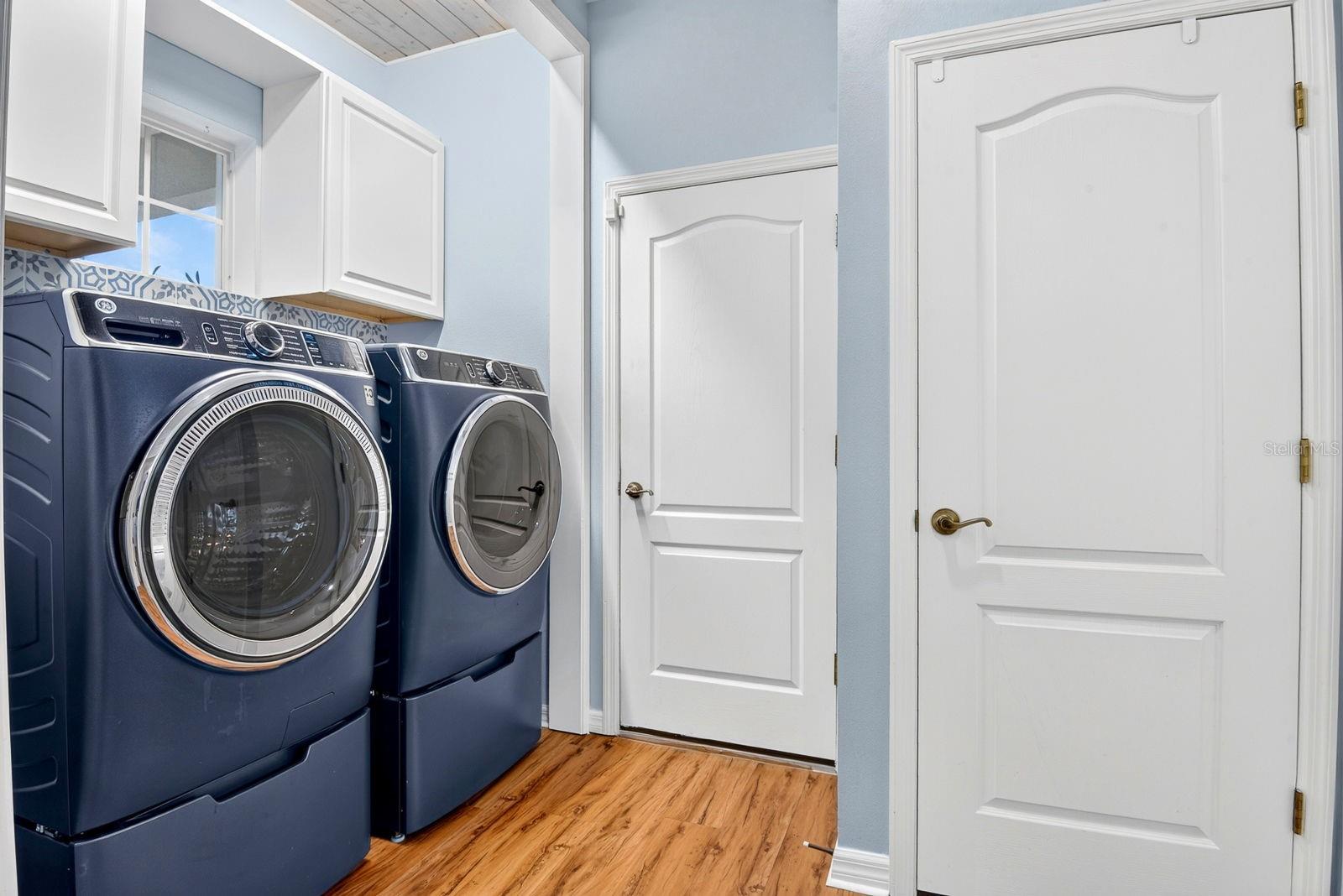 Laundry area by guest bedroom and garage door