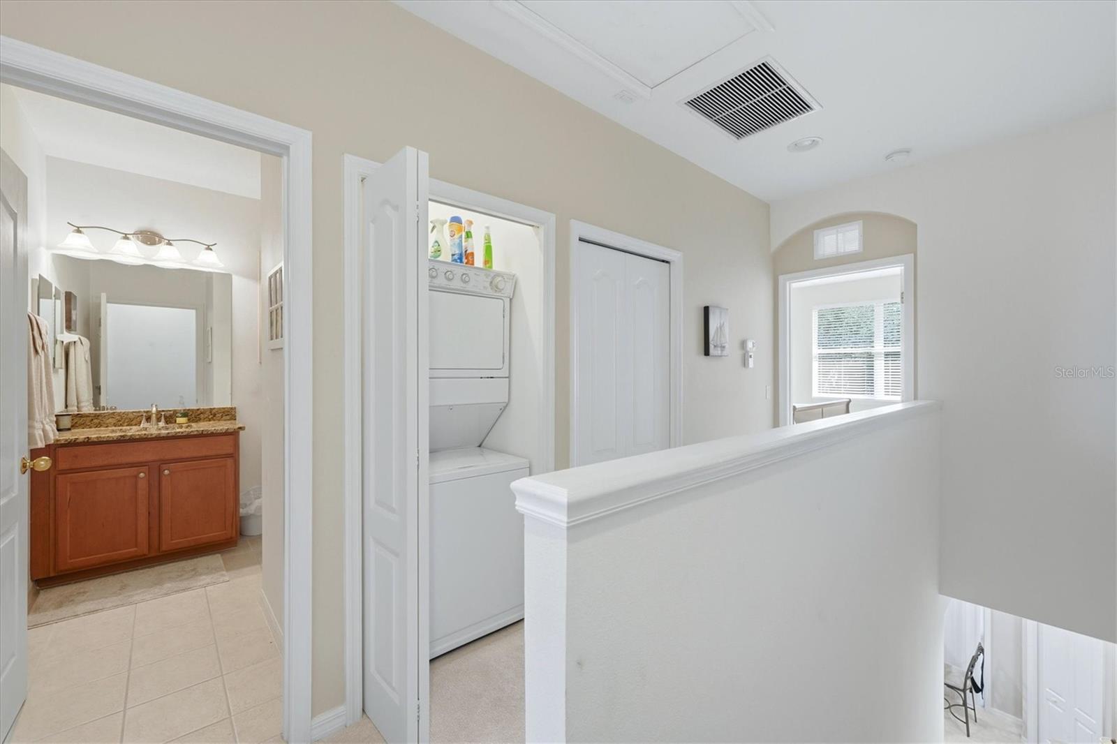 Stack washer/dryer off hallway