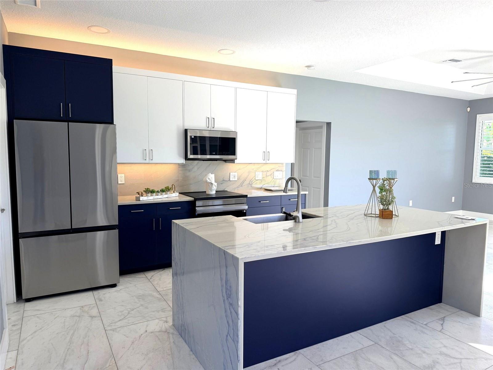 Kitchen View of Island and Refrigerator