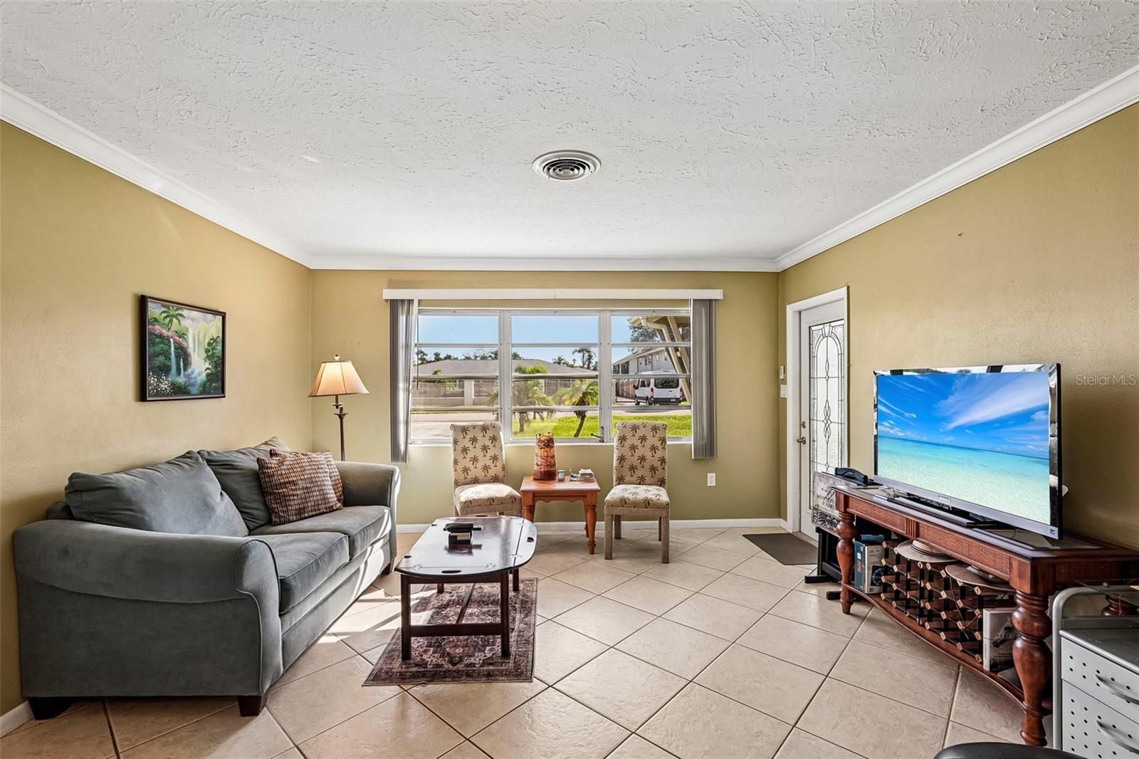 309 - open plan living room looking from kitchen, towards door to screened lanai.