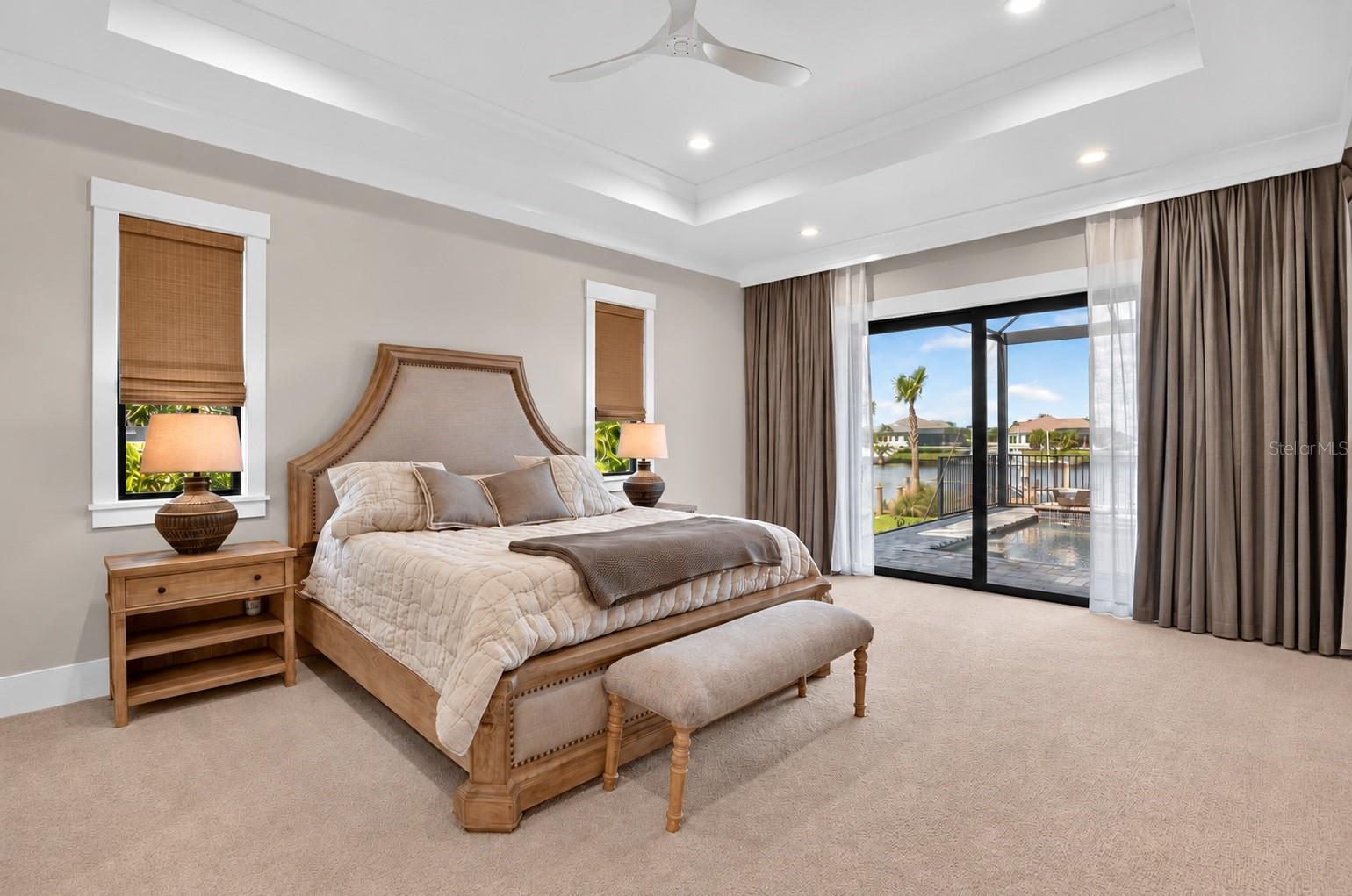 Owners Suite: Motorized Window Treatment.  Sliders lead to the lanai