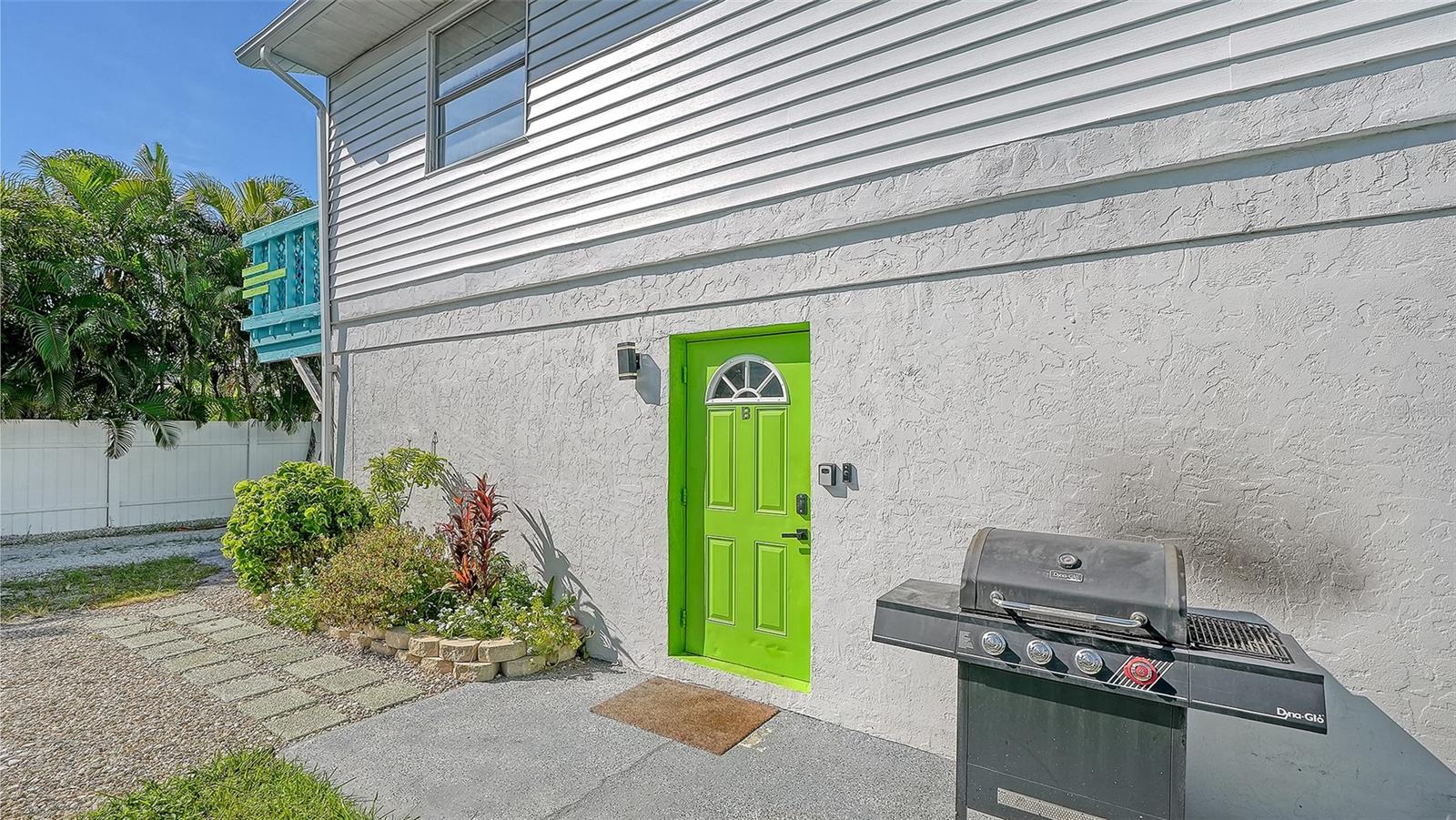 Both units have left side entrances. Green door, Unit B. Both units have a propane grill.