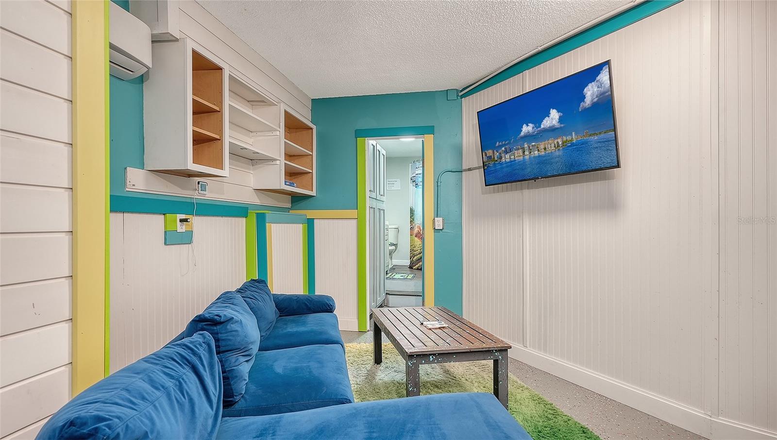 Ground floor under Unit B, converted garage to game or rec room/storage space.