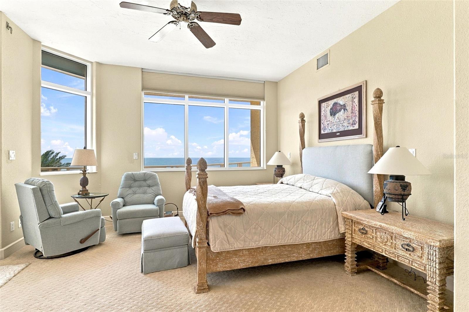 The primary suite has stunning views of the water and beach.