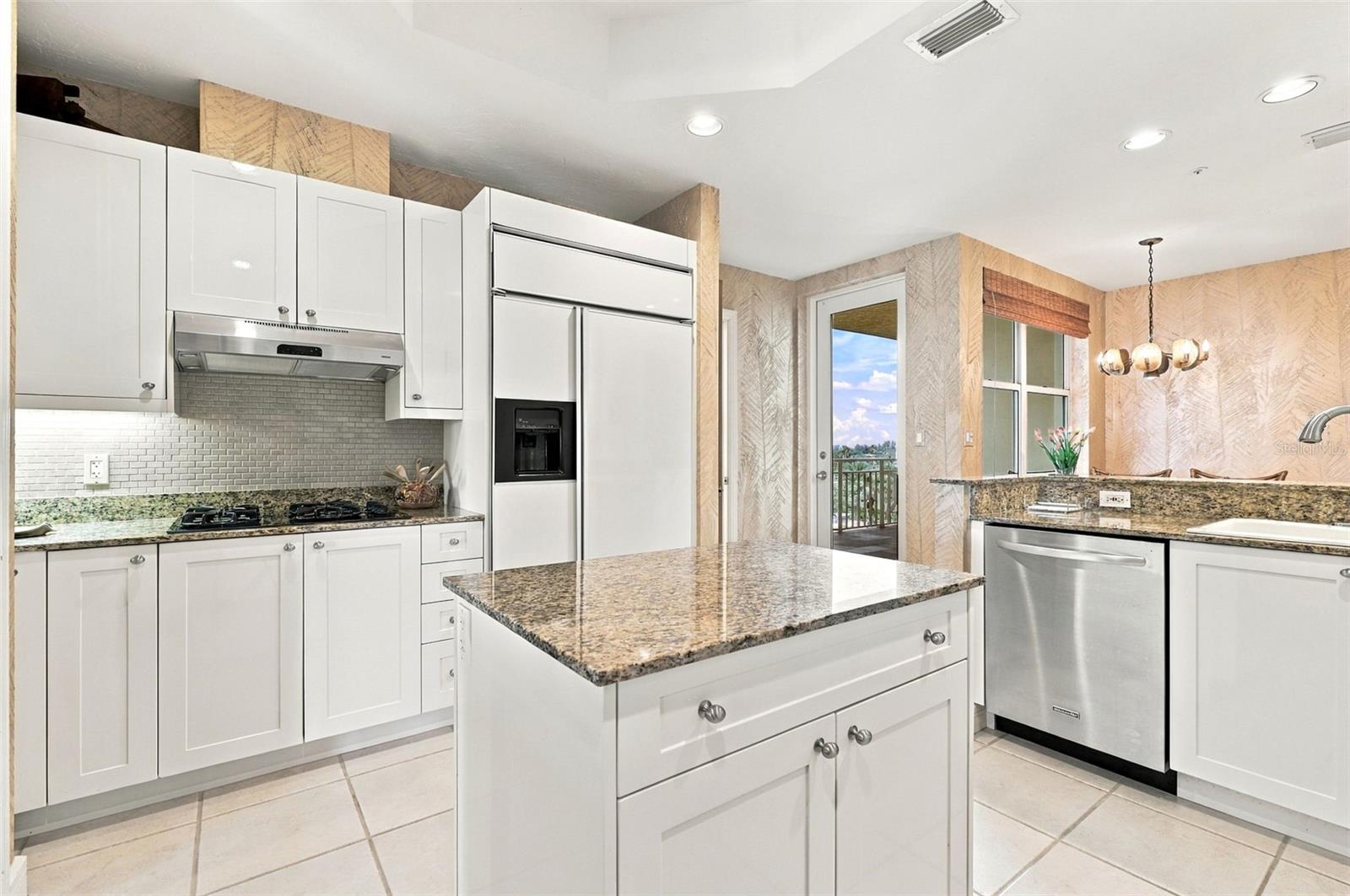 Cooktop with natural gas, under cabinet lighting and mini subway tile backsplash.