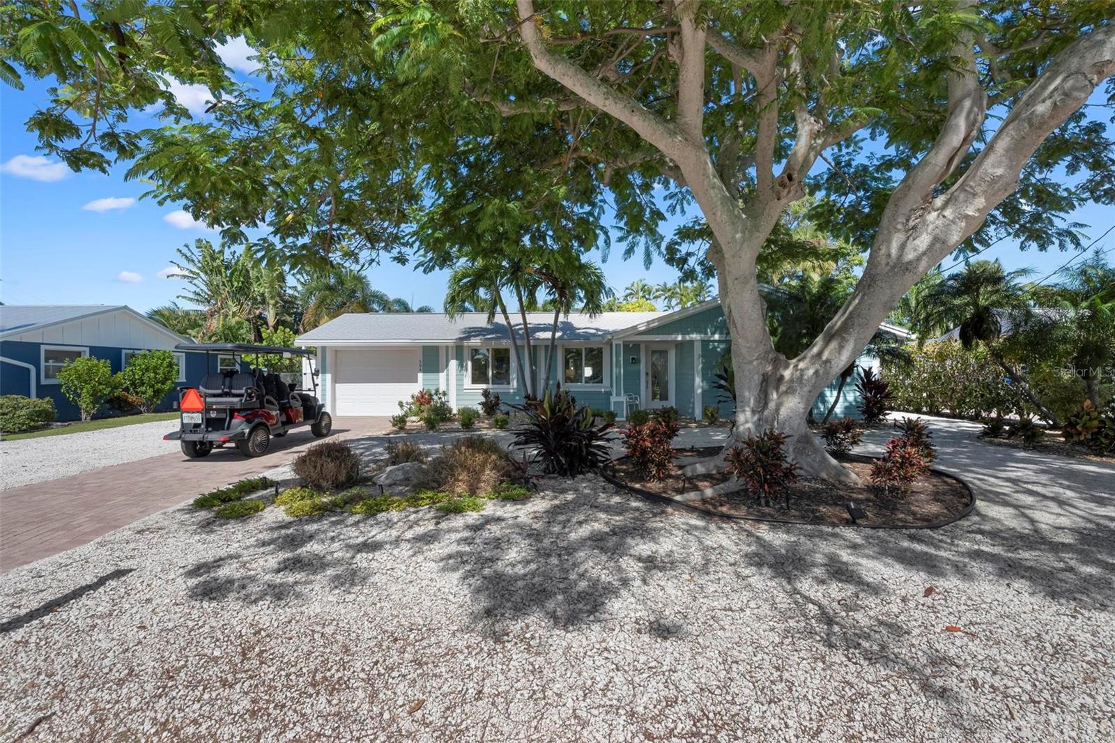 Front of home with beautiful poinciana tree