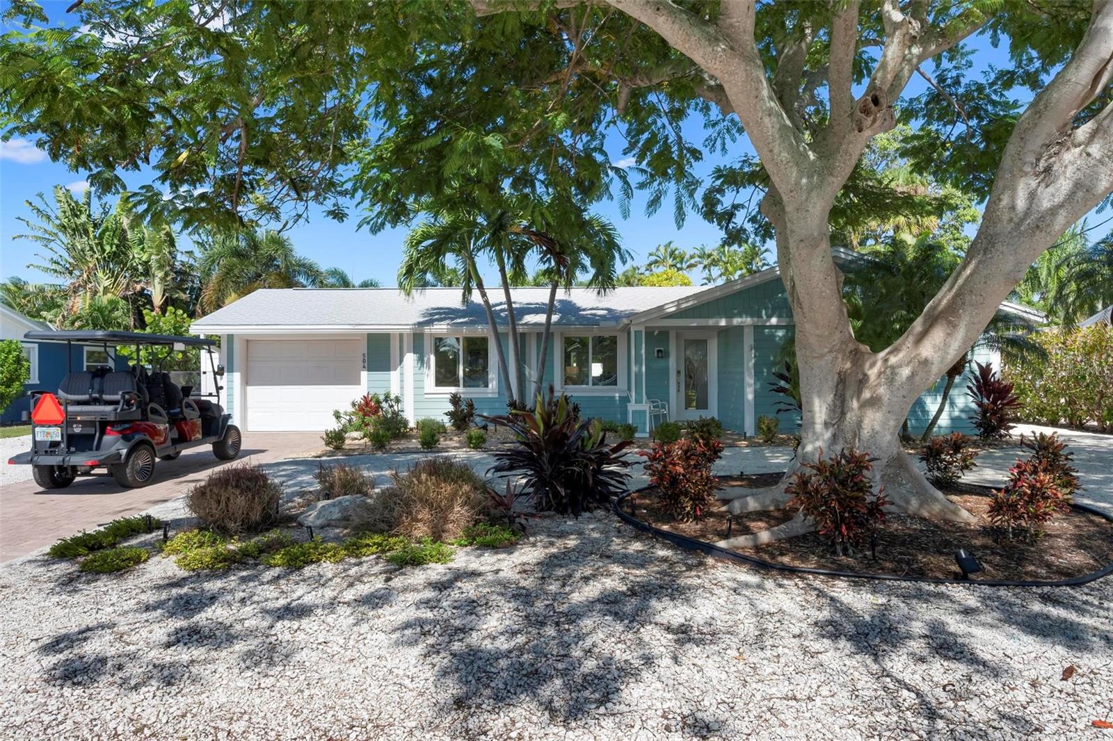 Front of home with beautiful poinciana tree