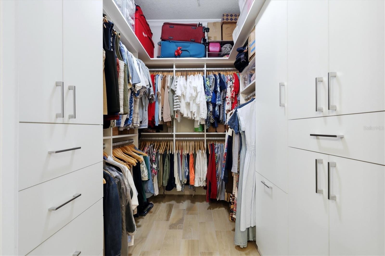 Primary walk-in closet with custom built-ins