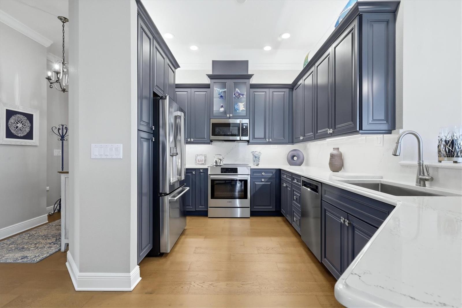 Kitchen has custom cabinetry, quartz countertops.
