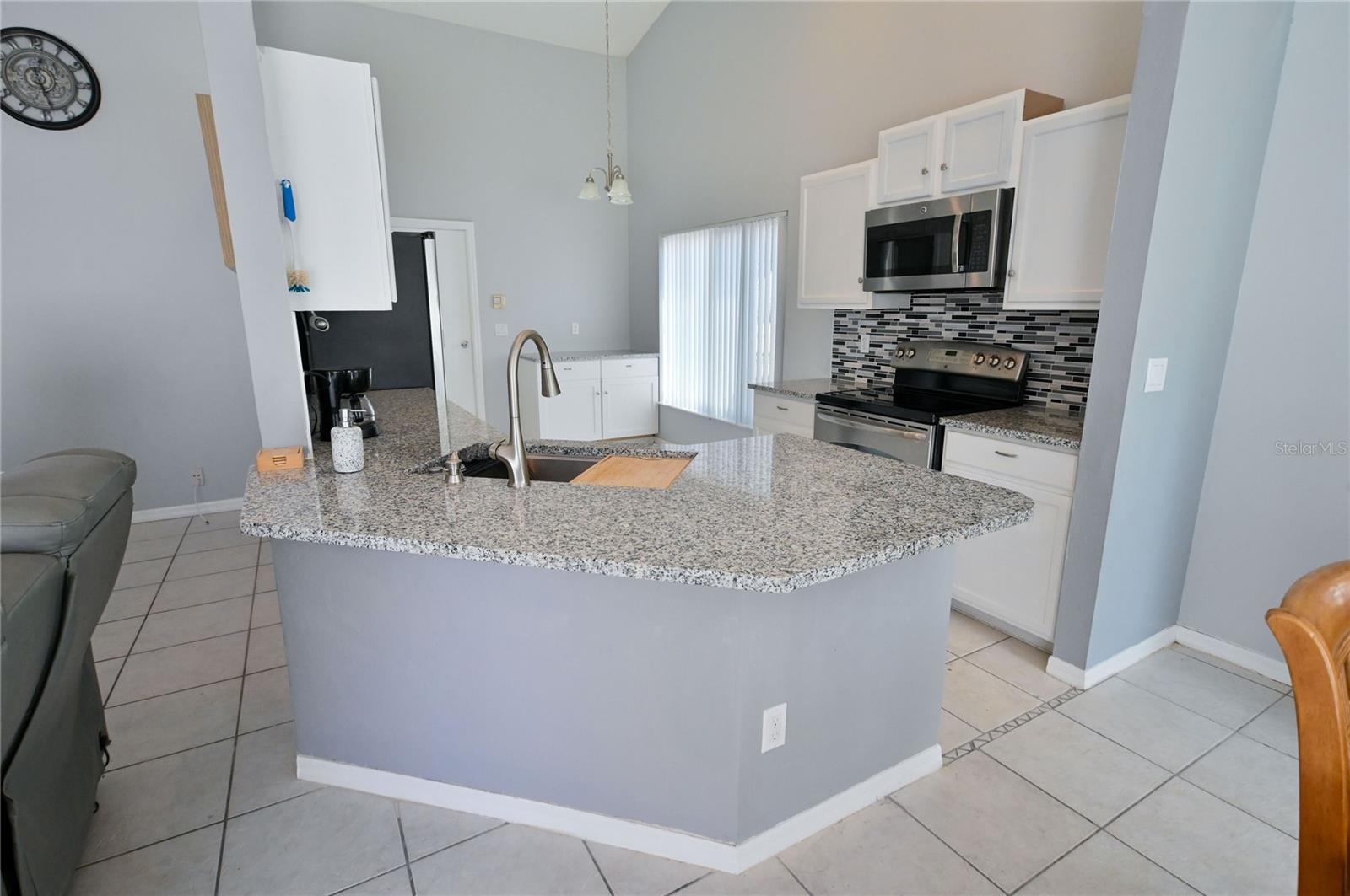 Open to living area. Garage access from kitchen