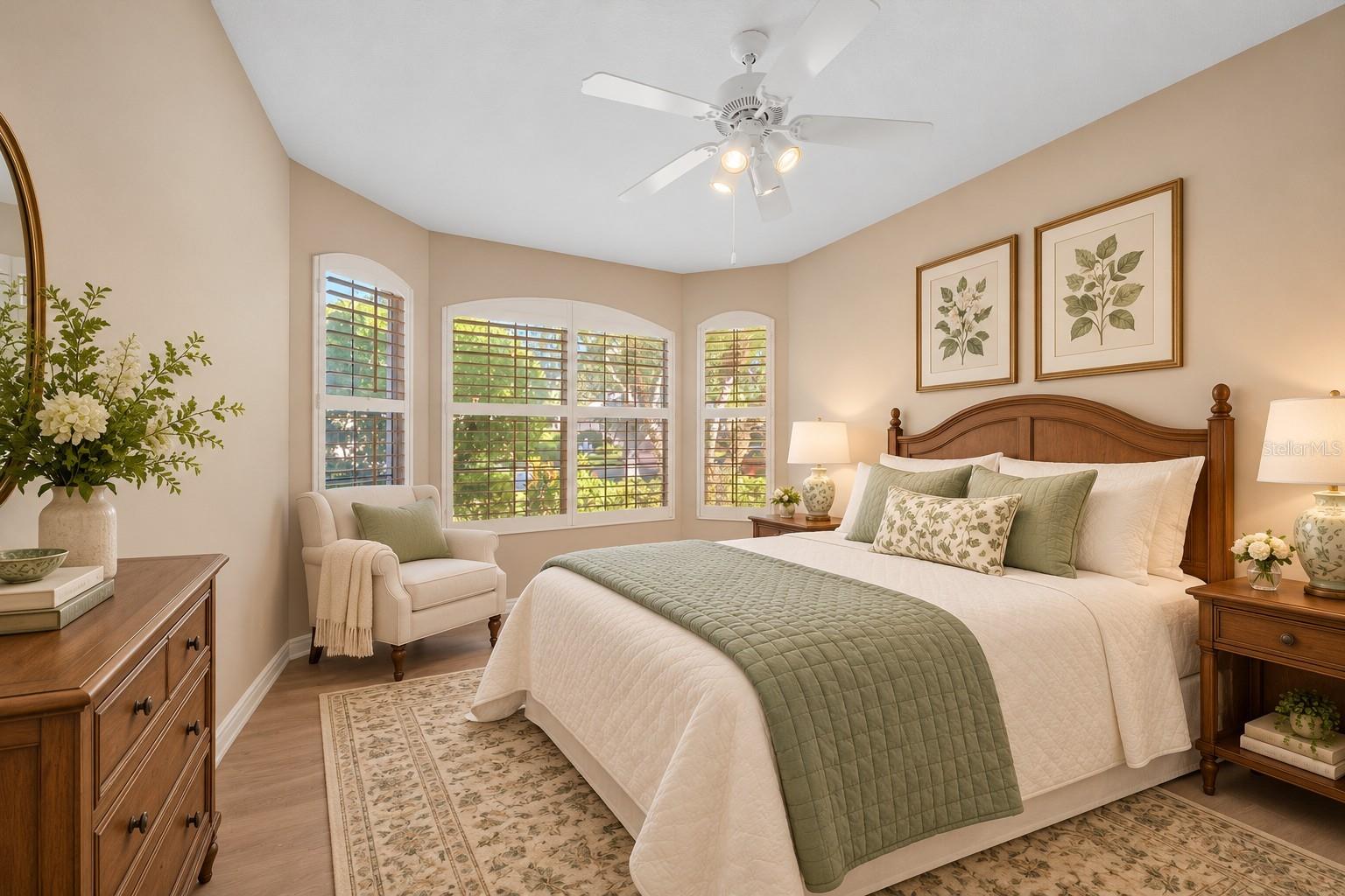 Guest Room with beautiful bay window and plantation shutters.
