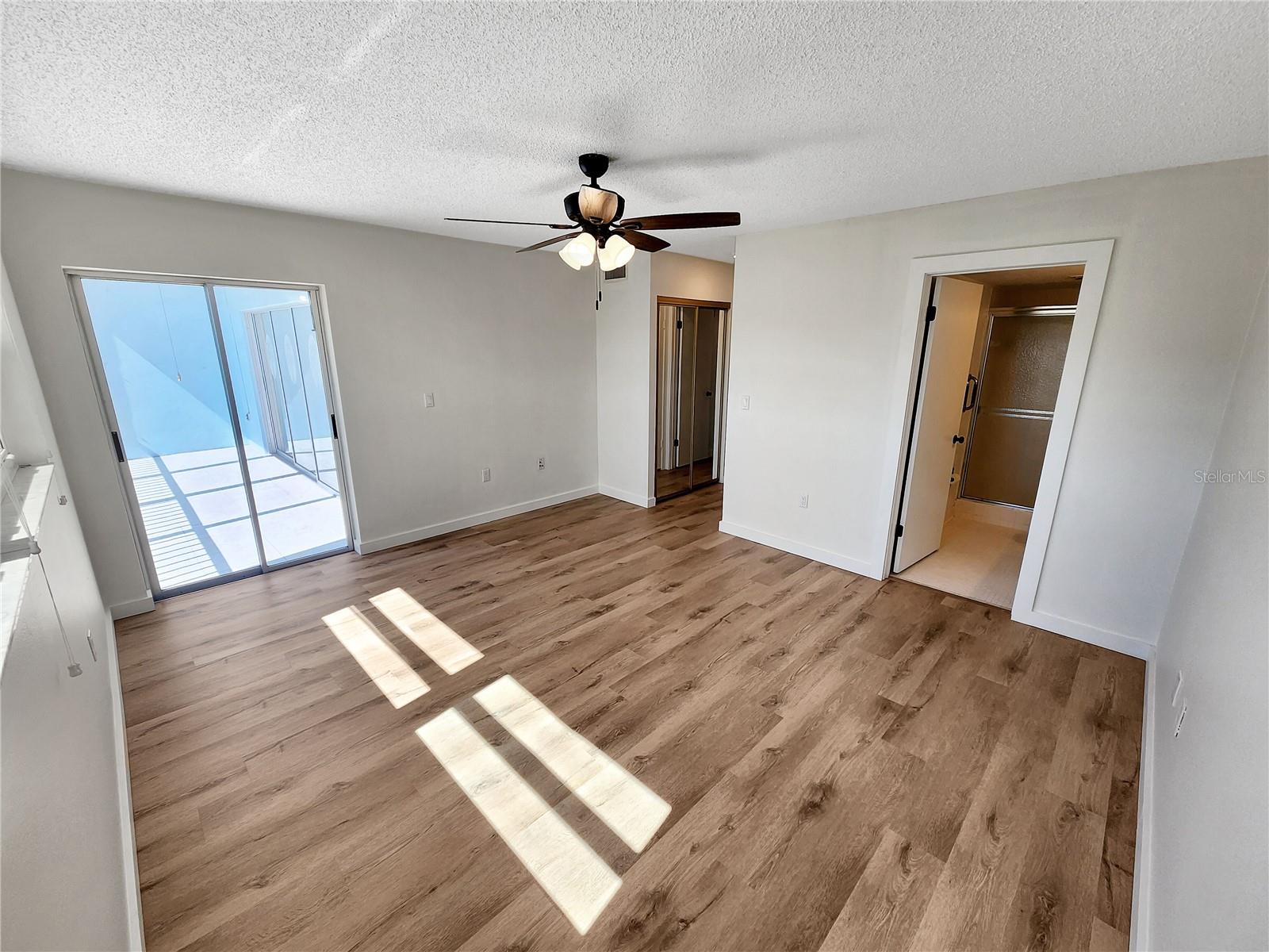 Primary bedroom with door to balcony
