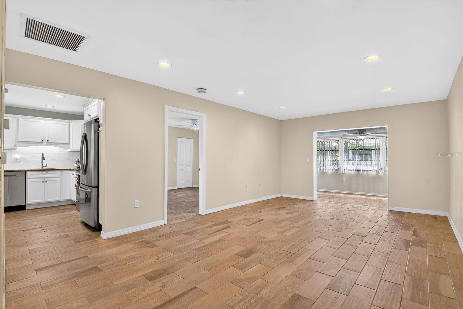 Living Room to Dining Area and Kitchen and Primary Bedroom