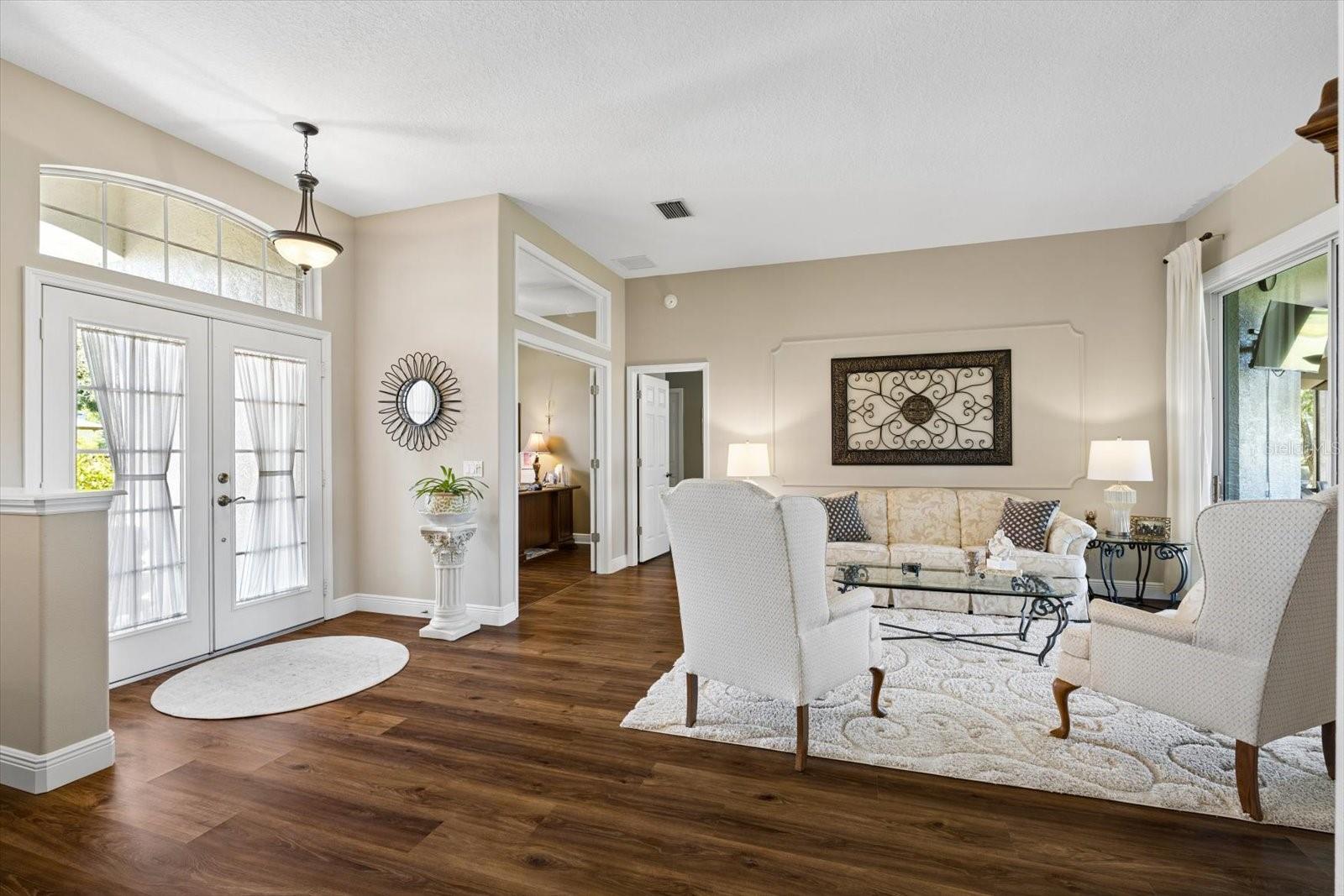Formal living room overlooking the patio and golf course