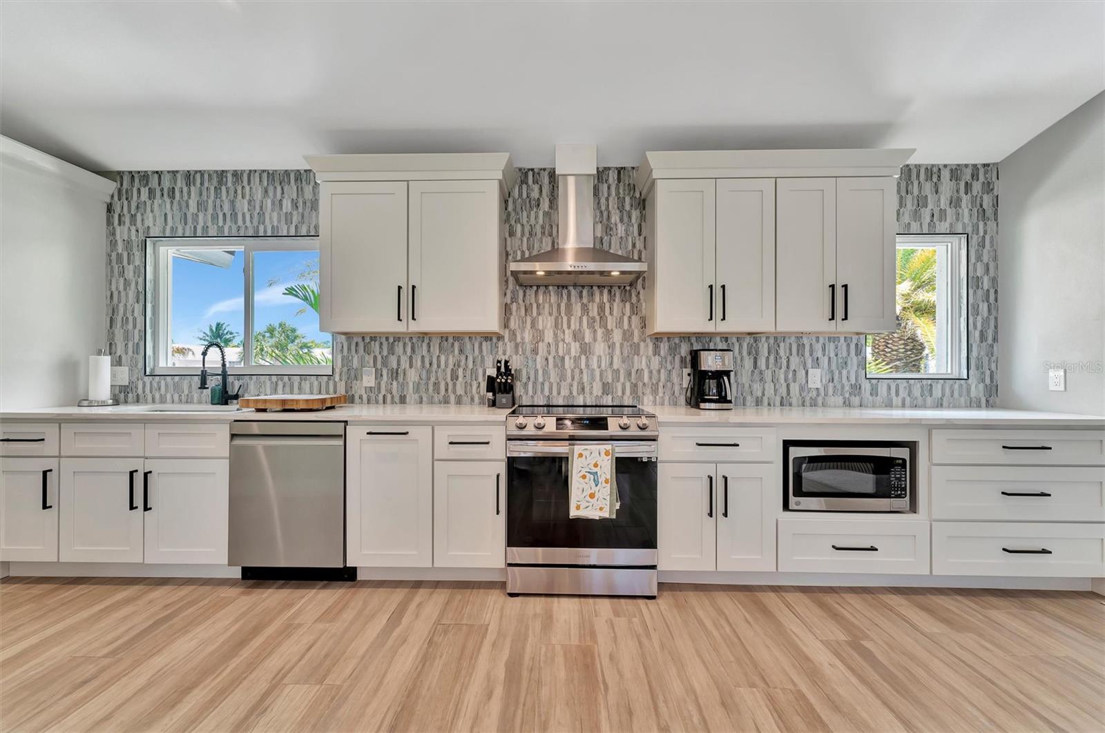 Chef-inspired kitchen with quality appliances, wine and beverage refrigerators, and wet bar.