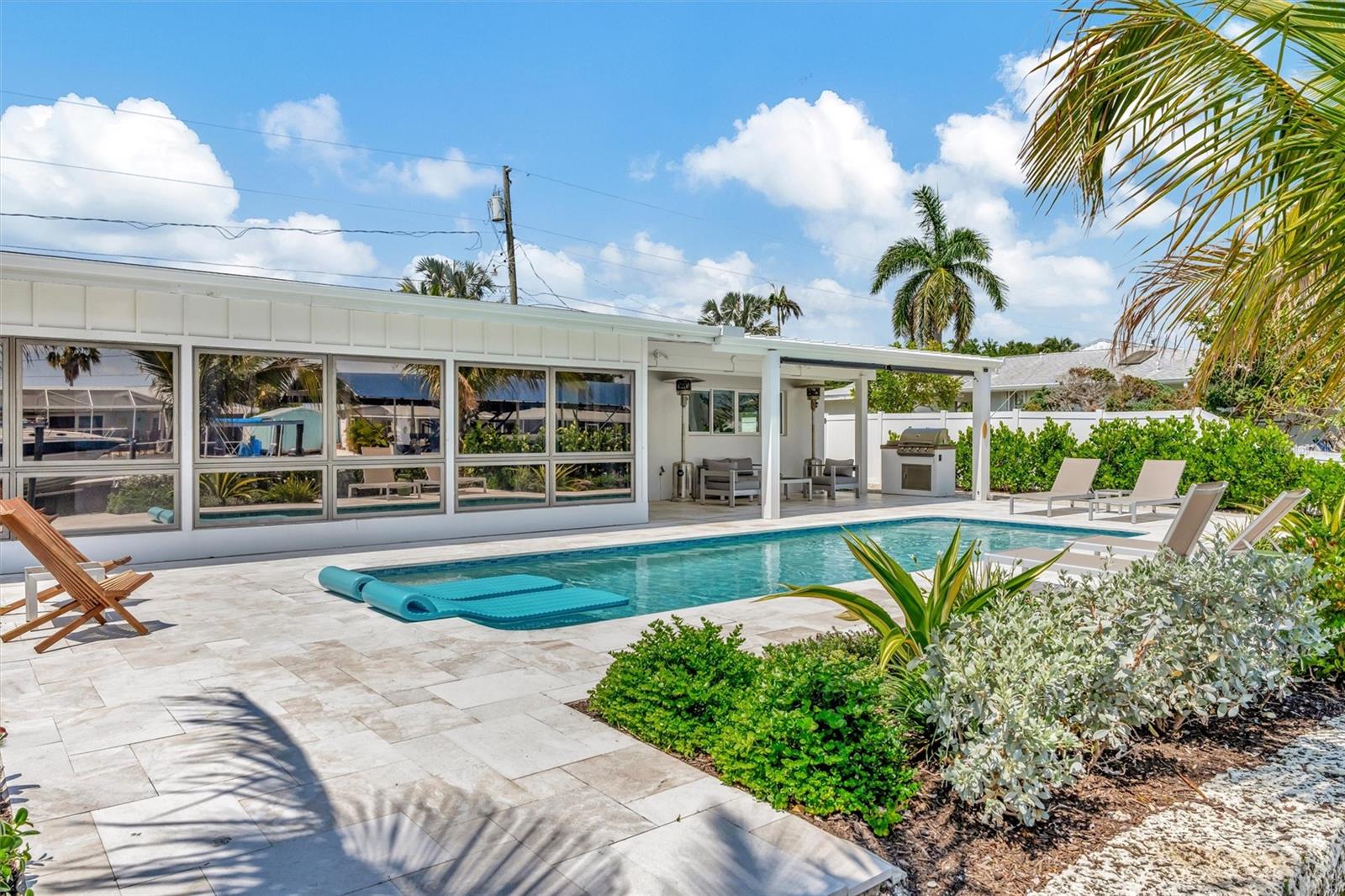 Heated saltwater pool, covered lanai, outdoor terraces, built-in propane grill, and tiki hut with turf games area. Heated saltwater pool, covered lanai, outdoor terraces, built-in propane grill, and tiki hut with turf games area.