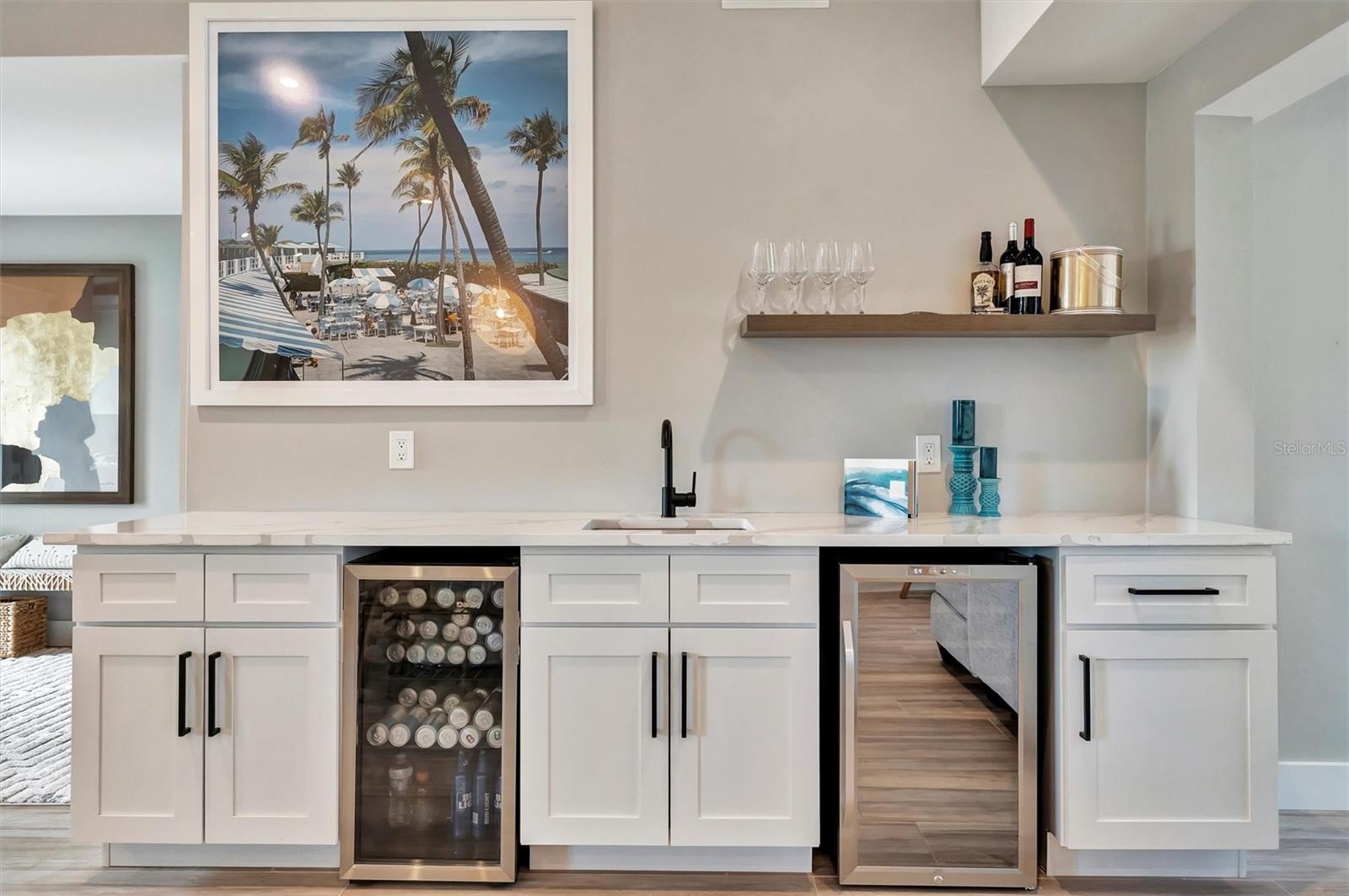 Chef-inspired kitchen with quality appliances, wine and beverage refrigerators, and wet bar.