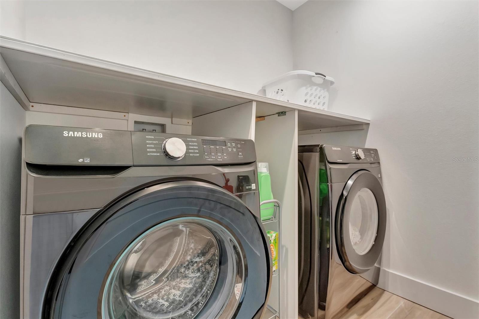 Indoor laundry with extra storage, two-car garage with epoxy floors, and low-maintenance irrigated yard.