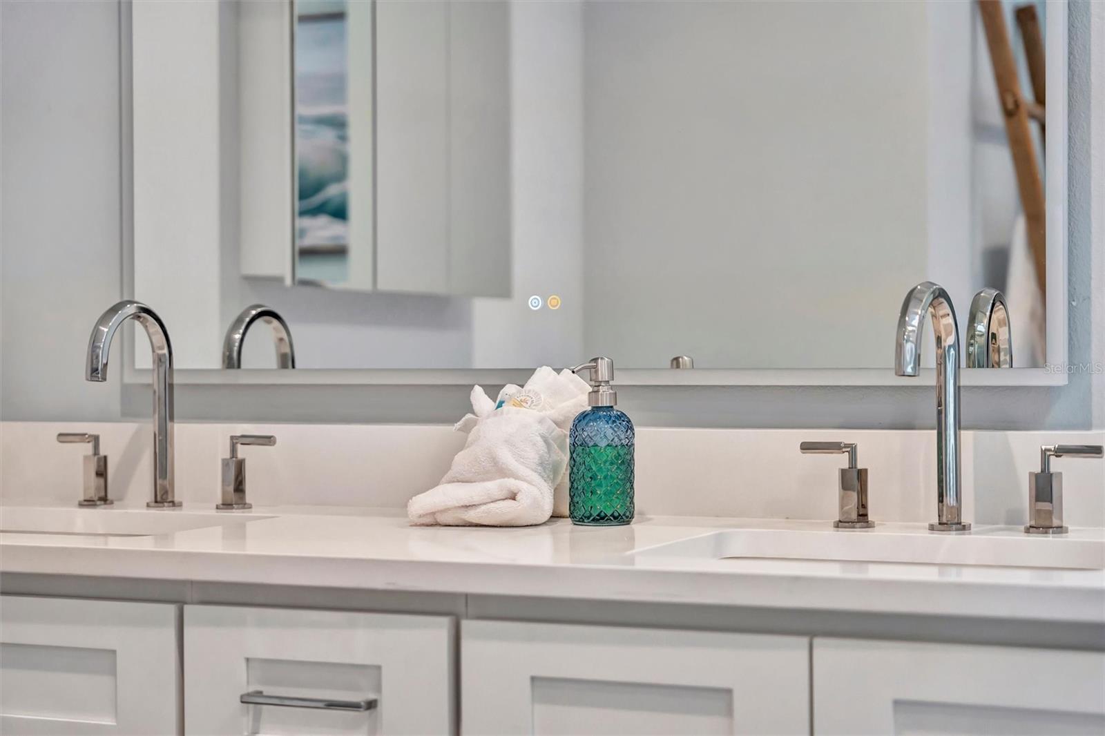 Spacious primary ensuite with double vanity and walk-in rain shower.