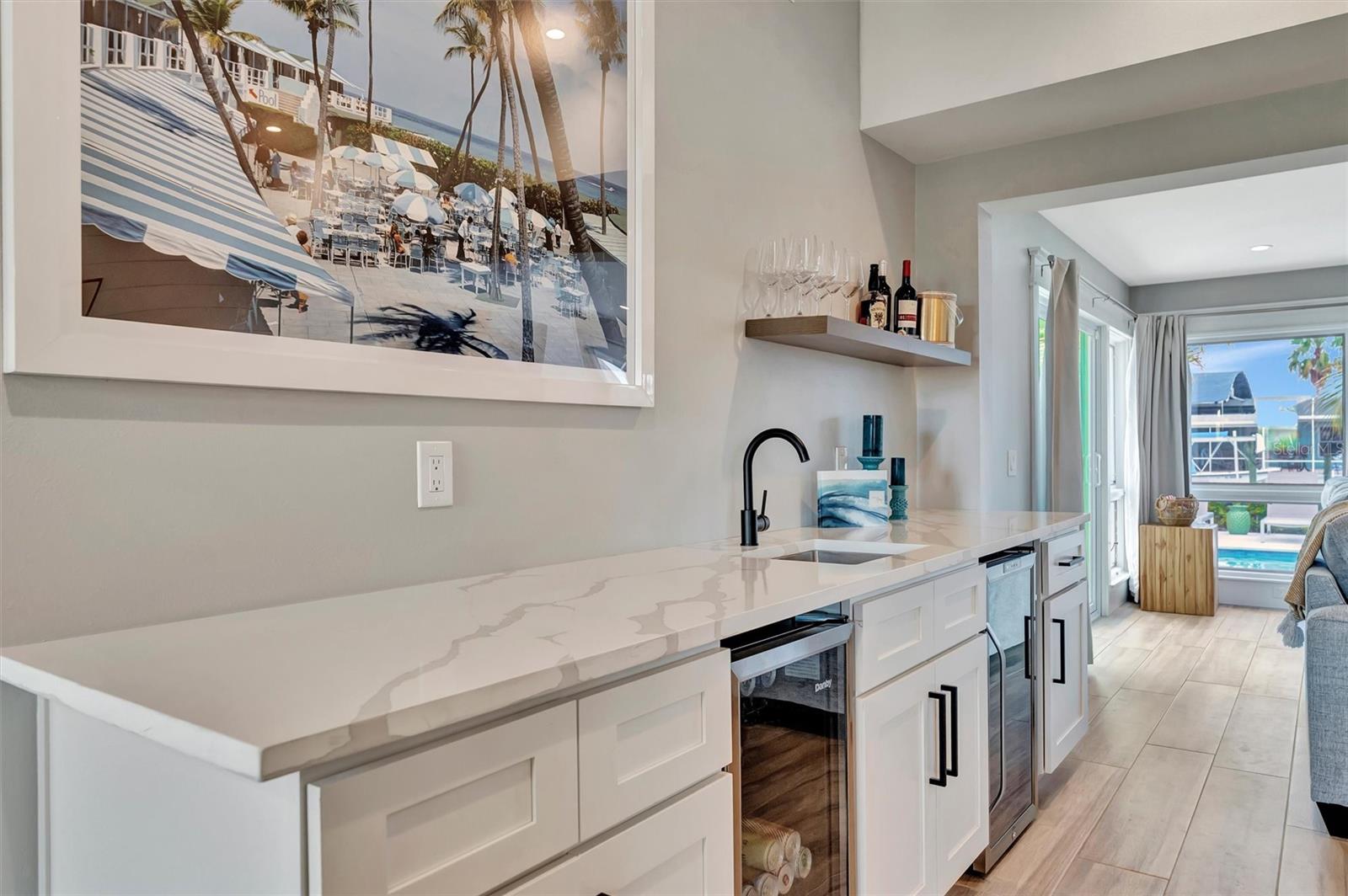 Chef-inspired kitchen with quality appliances, wine and beverage refrigerators, and wet bar.