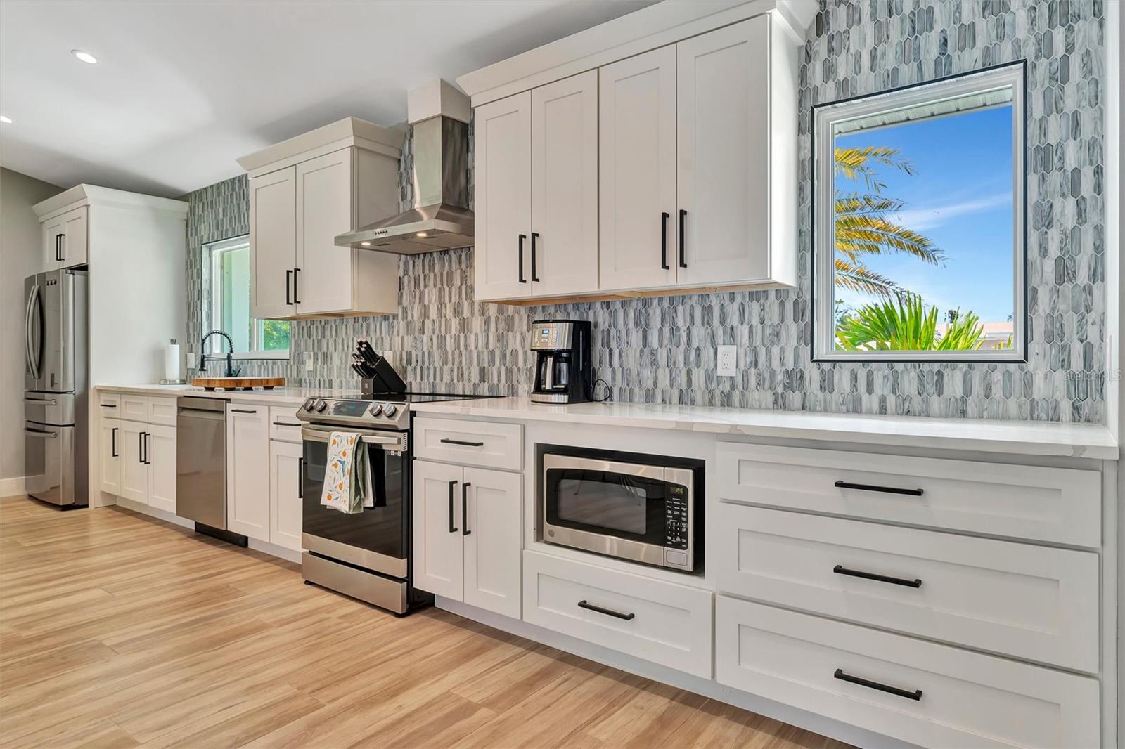 Chef-inspired kitchen with quality appliances, wine and beverage refrigerators, and wet bar.